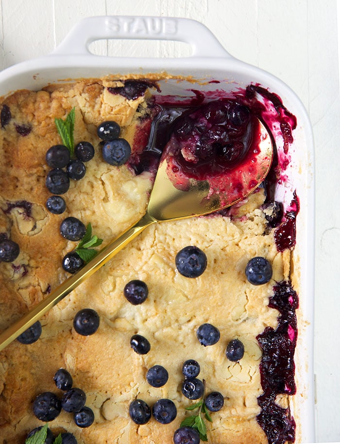 Overhead shot of blueberry dump cake in a white baking dish.