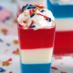 Close up of a layered red white and blue vodka jello shot.