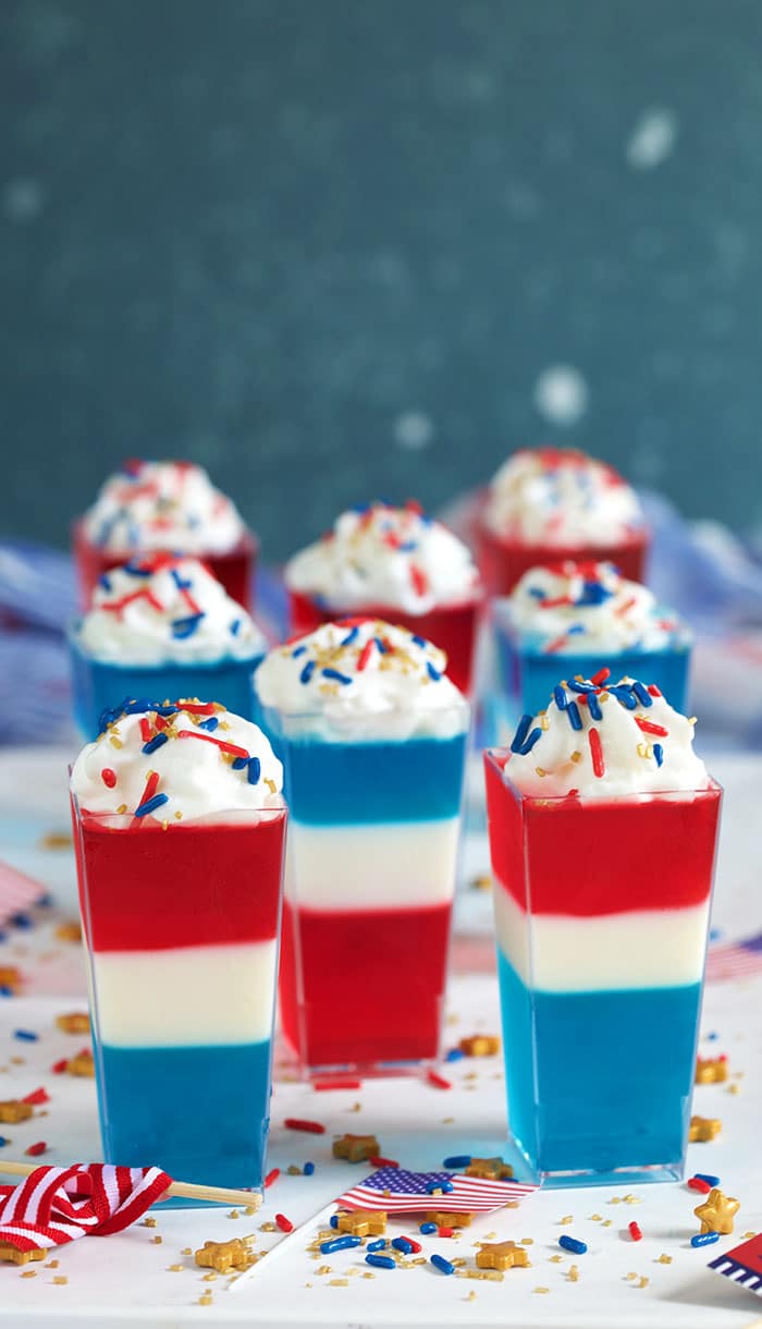 Red white and blue jello shots on a white background.