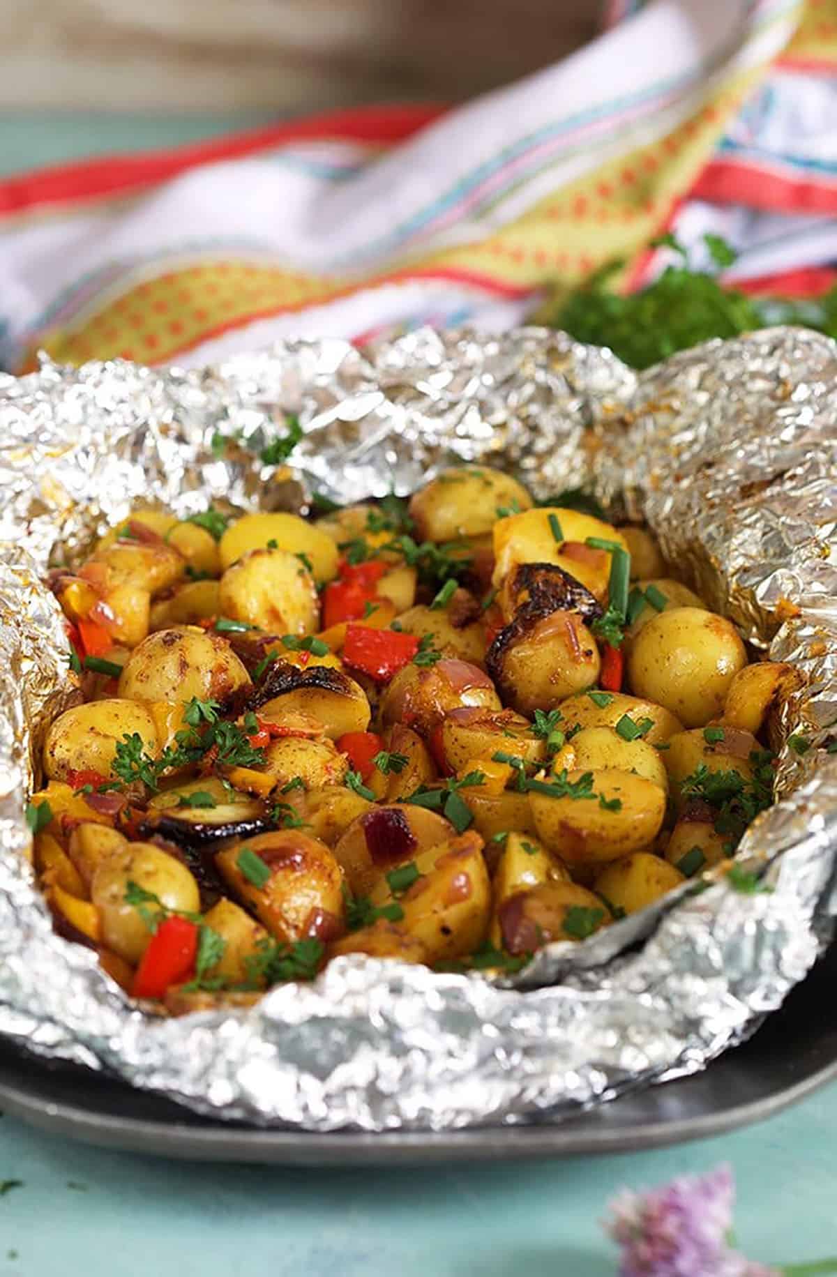 grilled potatoes in foil with pepper, onions and garlic.