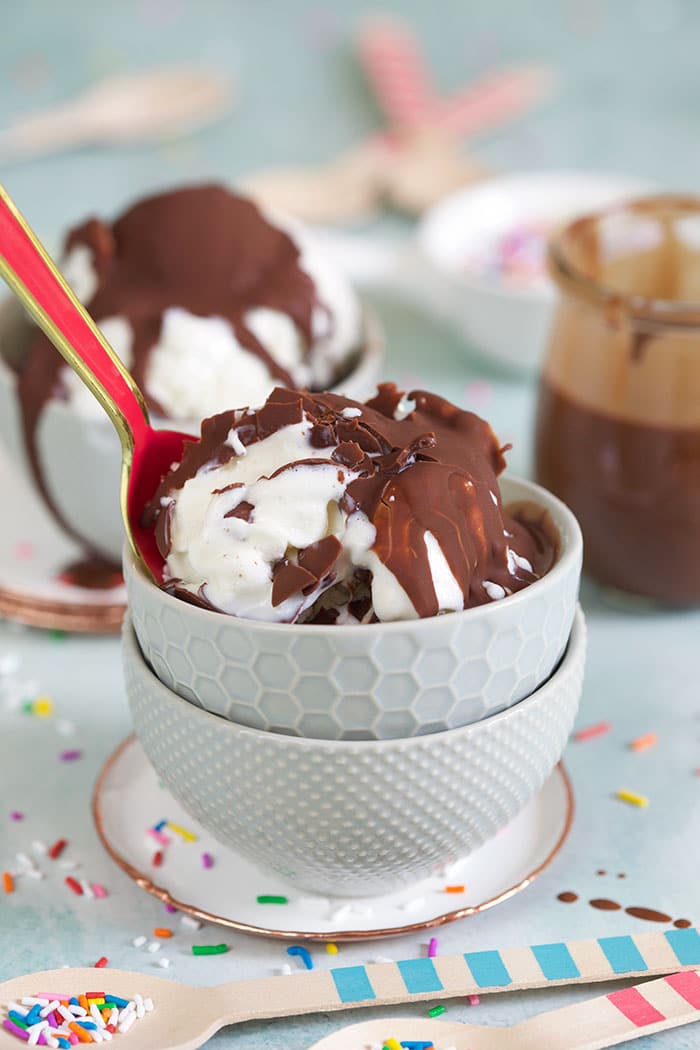 Magic shell on vanilla ice cream in a gray bowl.