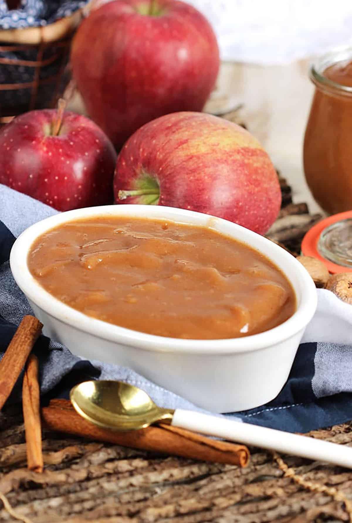 Apple butter in a white oval bowl on a twig placemat.