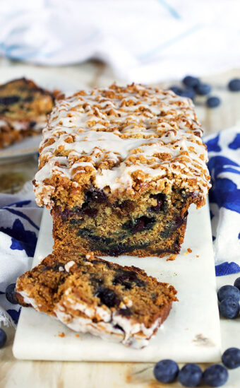Blueberry Banana Bread with two slices on a white marble boar