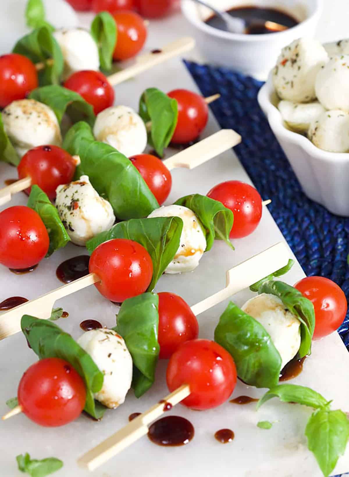 Caprese Salad Skewers on a marble tray.