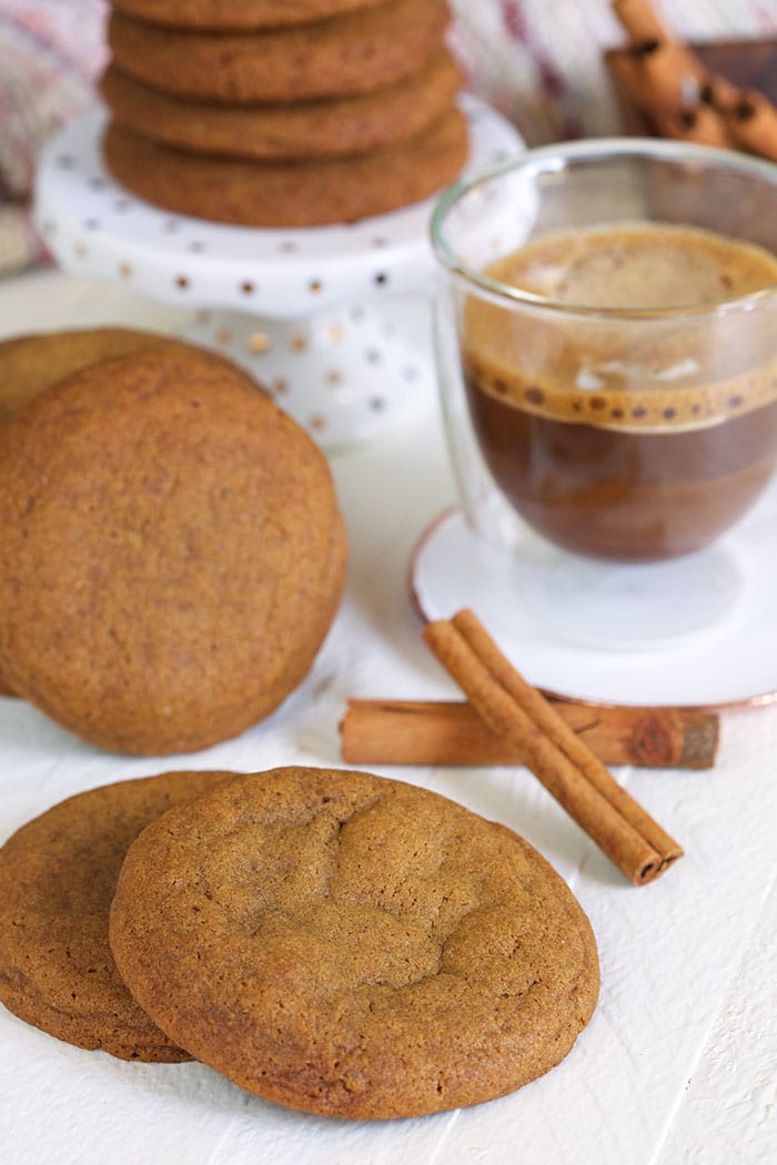 Gingersnap cookies on a white background with a cup of coffee in a glass mug.