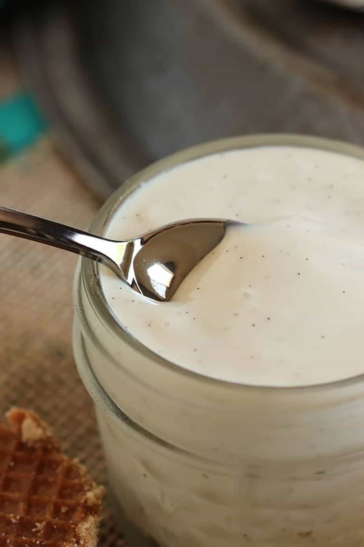 silver spoon in a jar of vanilla pudding