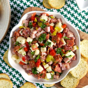 Hoagie dip in a white bowl with crostini around it.