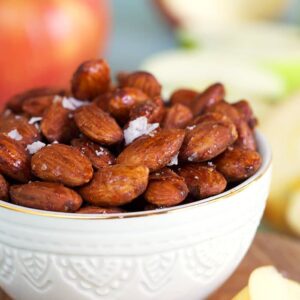 Roasted almonds on a white bowl.