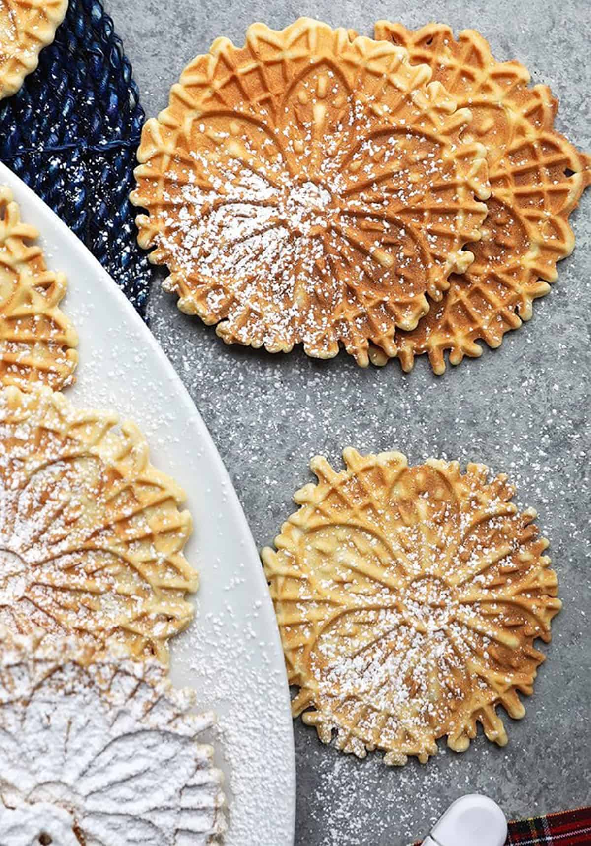 Pizzelles on a gray background.