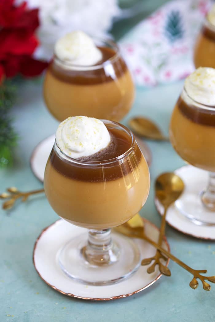 Butterscotch Pot de Creme in a mini brandy glass on a white coaster with a gold spoon.