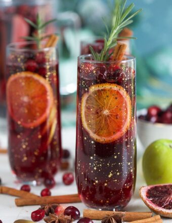 Christmas Sangria in a champagne glass with blood oranges and cranberries.