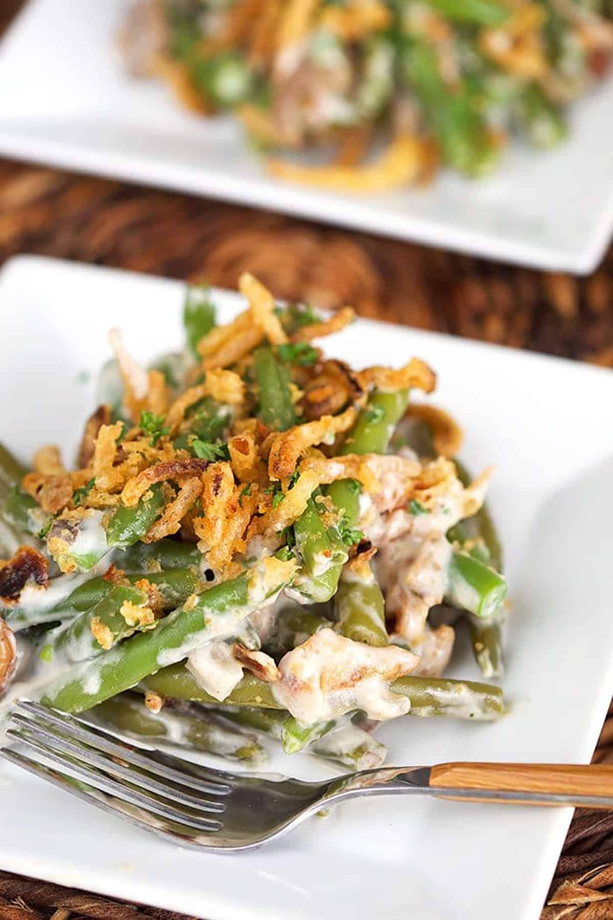 Green bean casserole on a square plate.