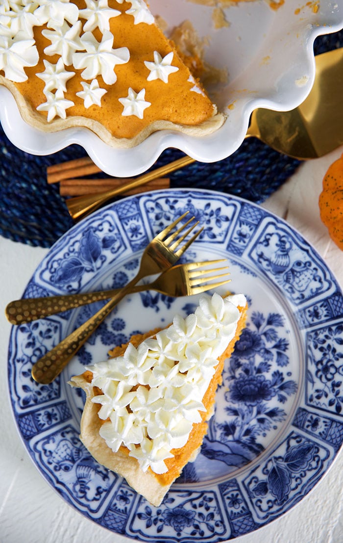 slice of pumpkin chiffon pie on a blue and white plate.