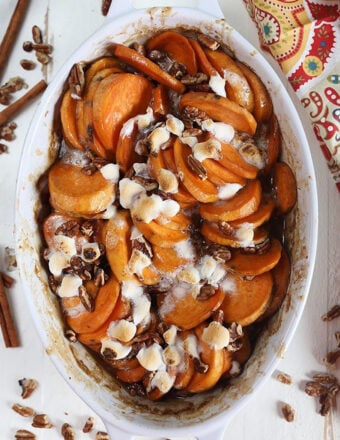 Overhead shot of candied yams in a white baking dish.