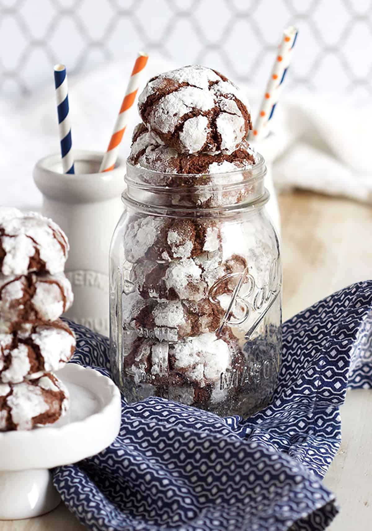 Chocolate Crinkle Cookies stacked in a canning jar.