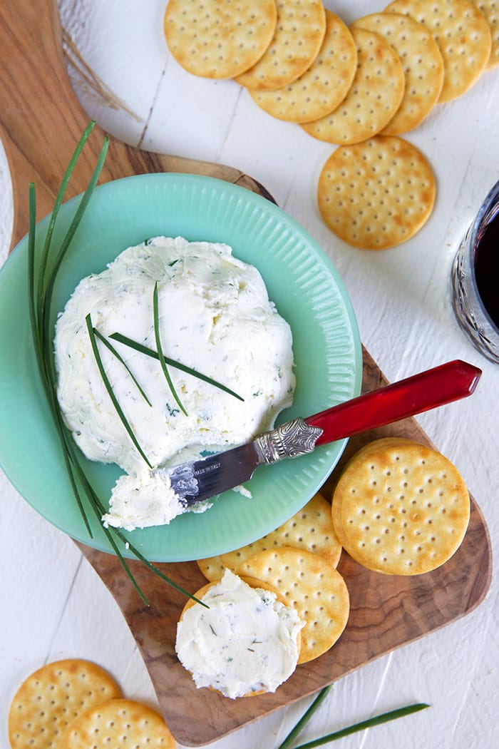 A blue bowl contains a large serving of Boursin cheese.