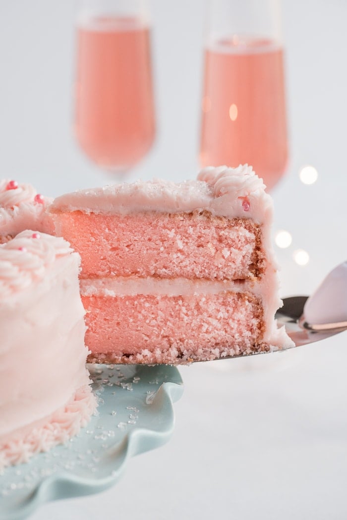 Slice of Pink Champagne Cake being served.