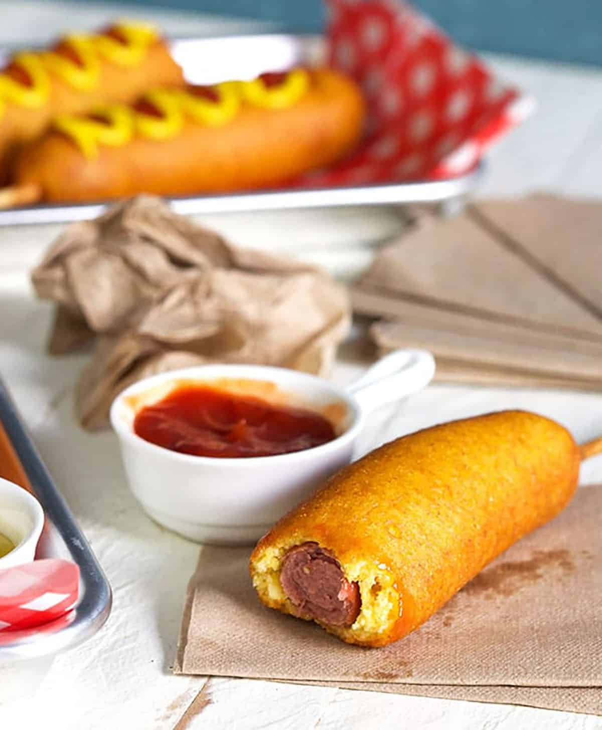 Corn dog with a bite out of it.