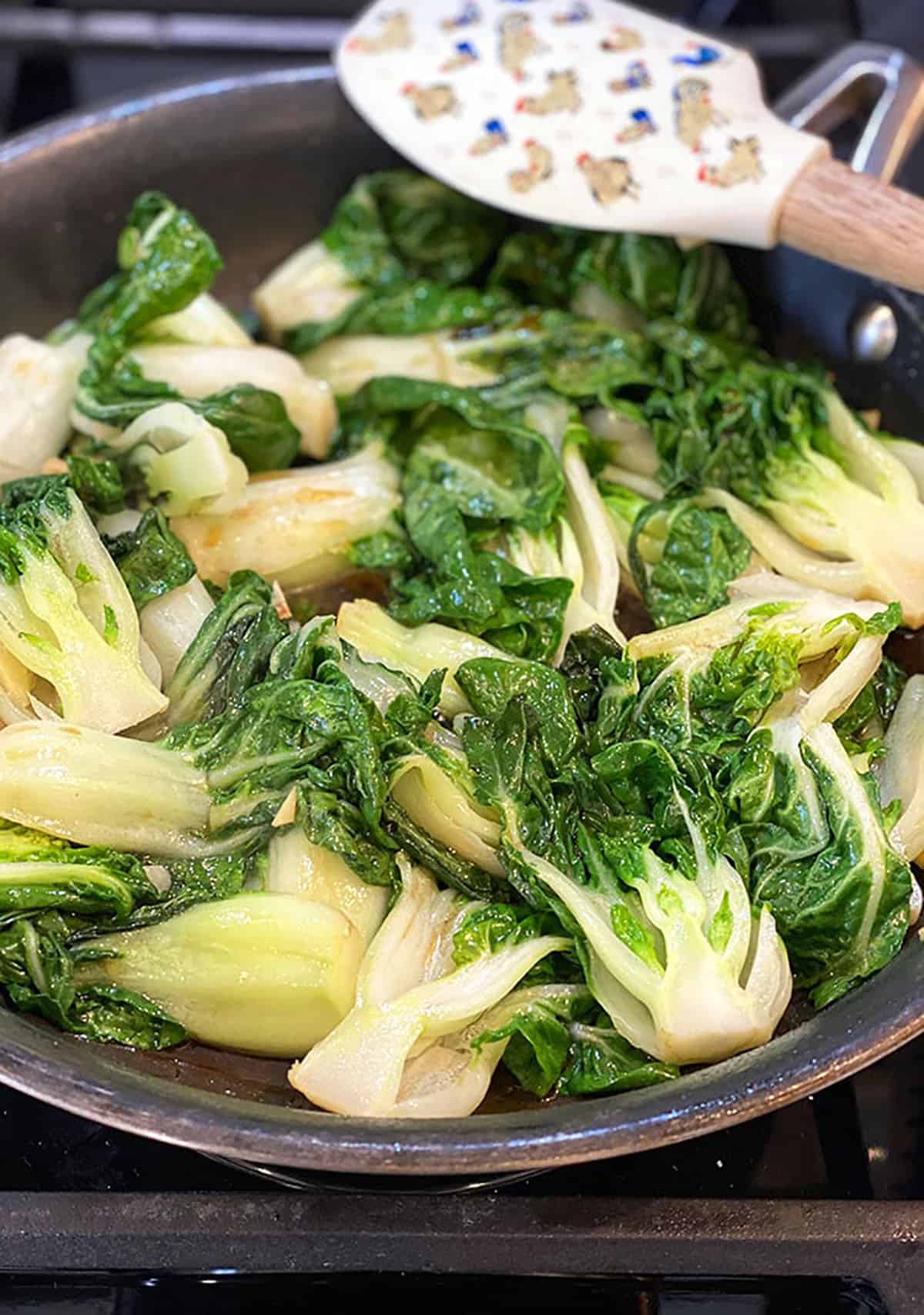 Bok Choy is cooked in a skillet 