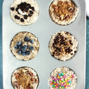 Overhead shot of muffin tin with steel cut oatmeal with various toppings