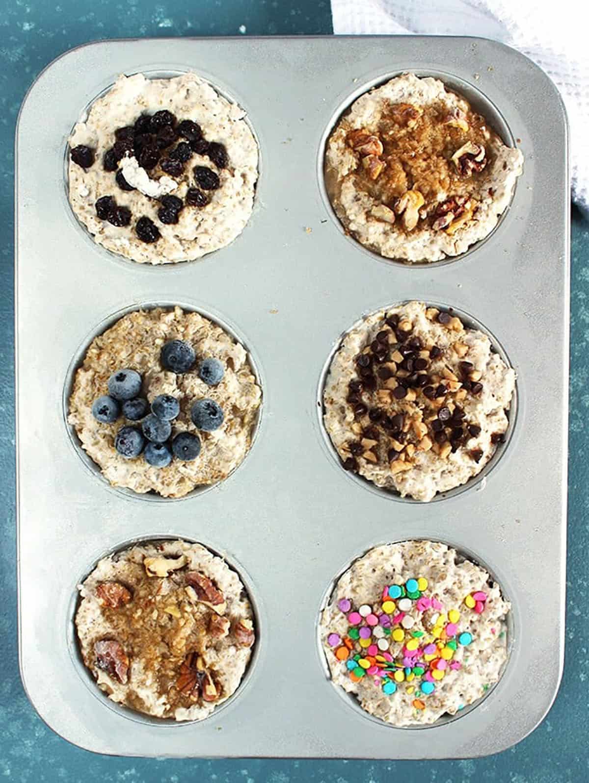 Overhead shot of muffin tin with steel cut oatmeal with various toppings