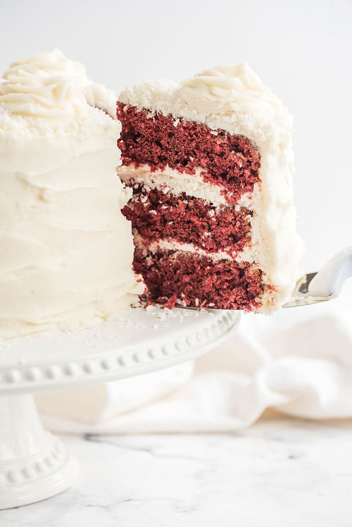 slice of red velvet cake being served with a cake server