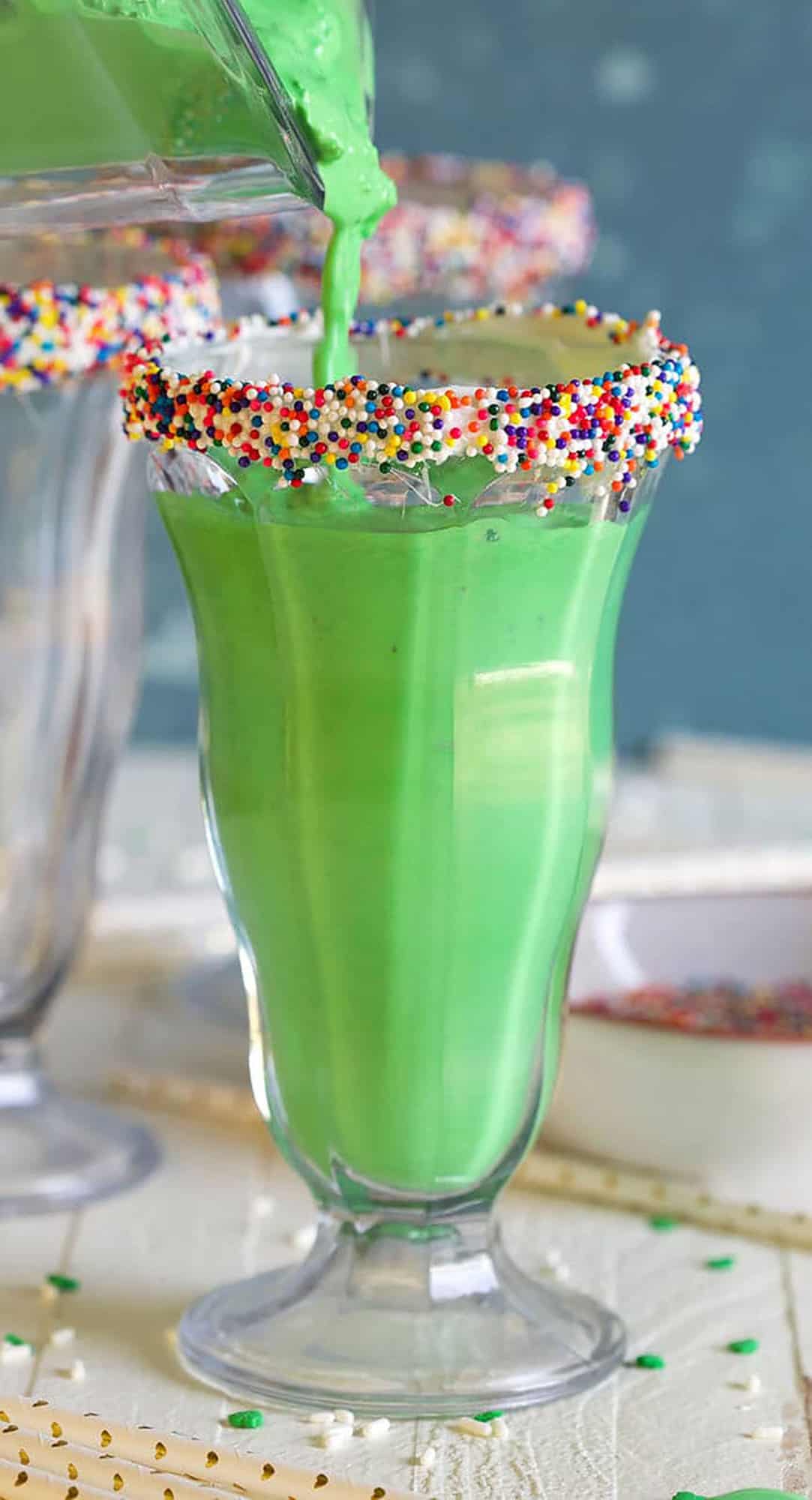 Shamrock shake being poured into a milkshake glass