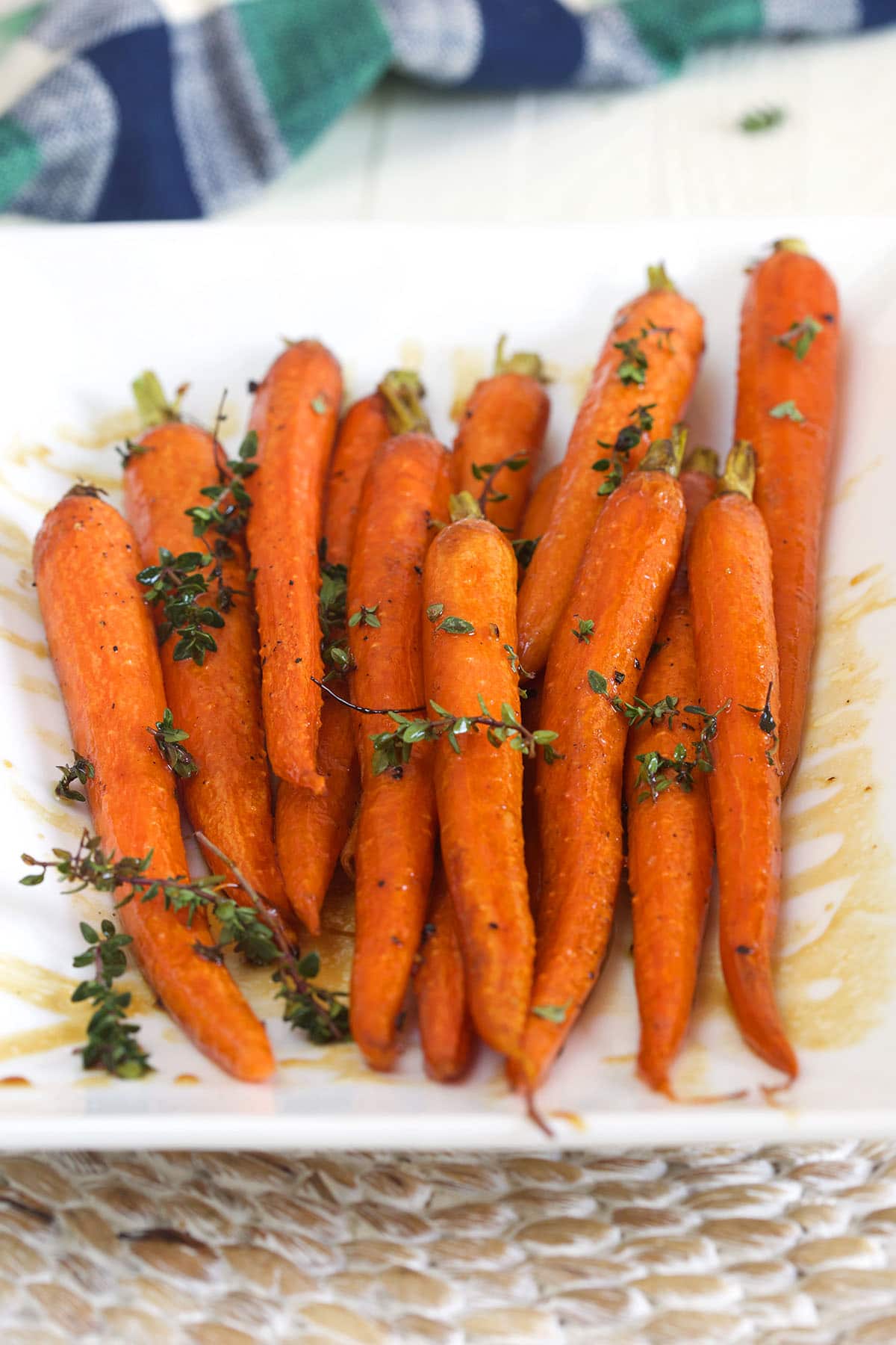 Roasted carrots are topped with fresh thyme.