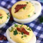 Bacon Horseradish Deviled Eggs on a blue and white gingham plate.