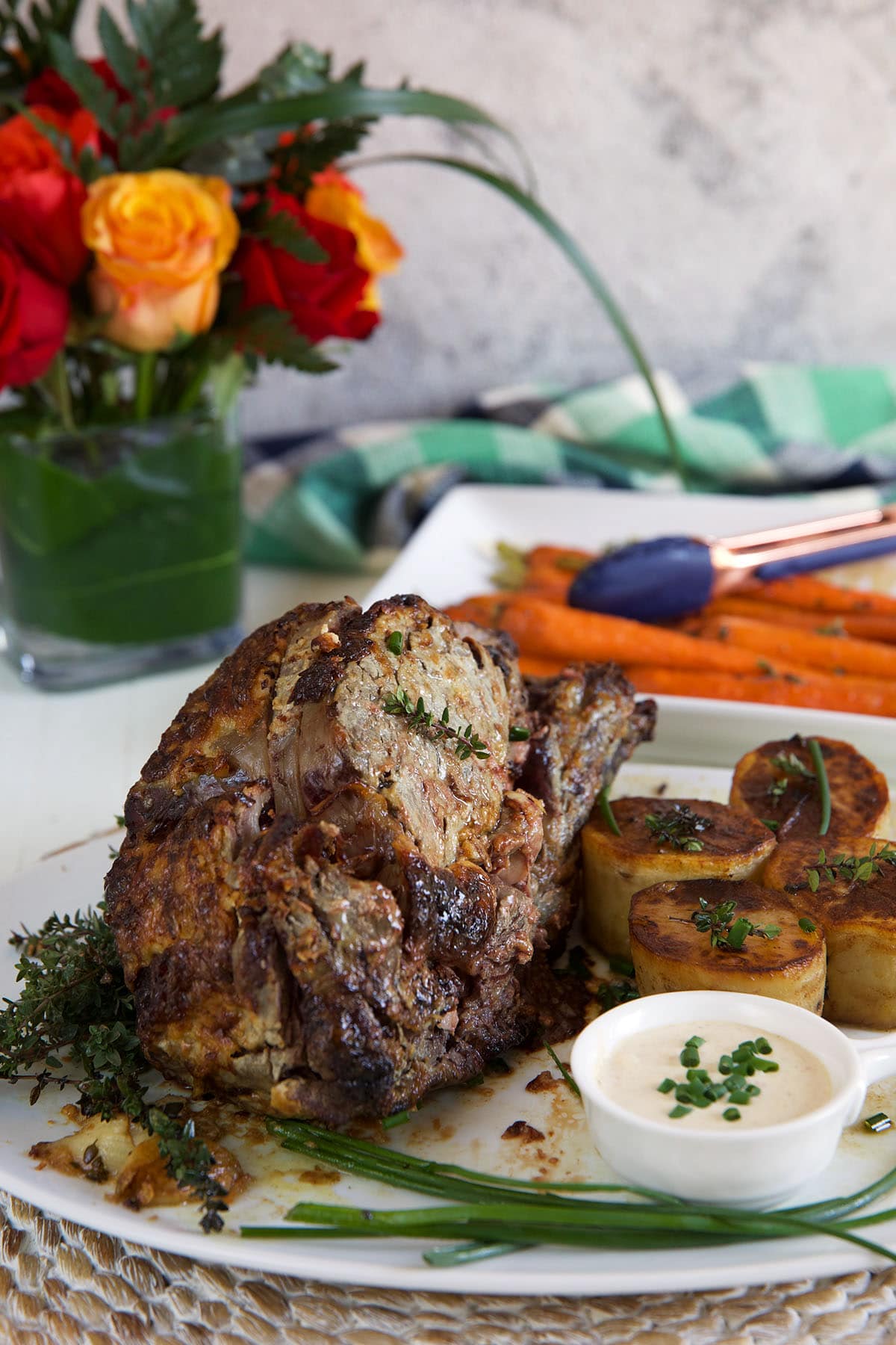 A prime rib roast is presented on a white plate.