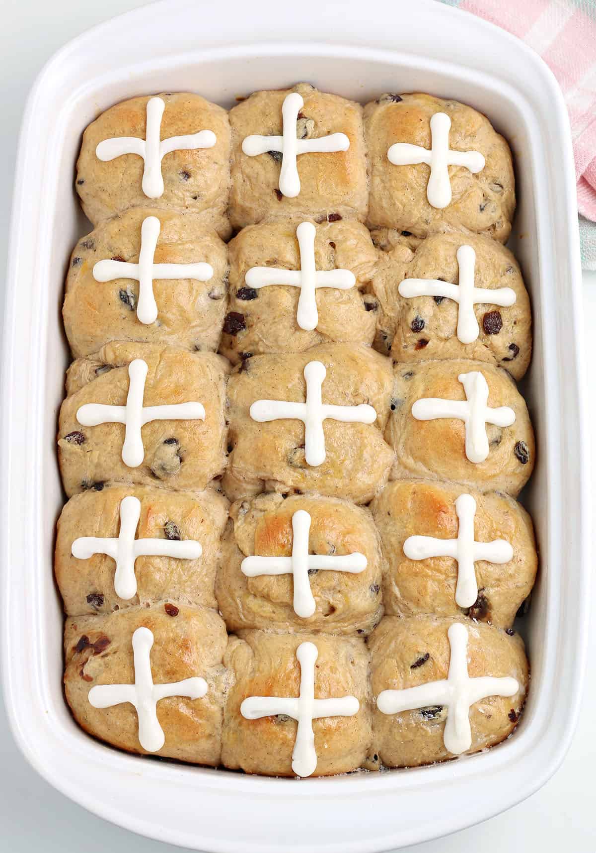 Hot Cross Buns baked in a white baking dish.
