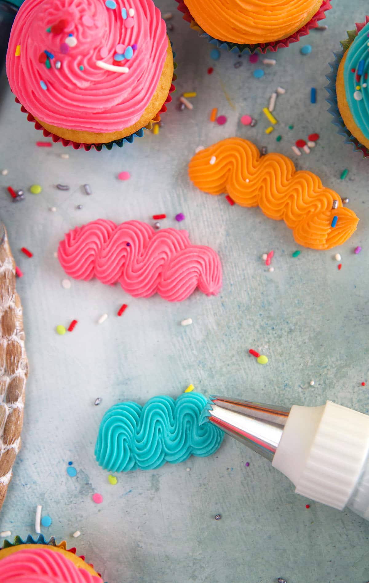 Squiggles of frosting are piped onto a parchment paper.