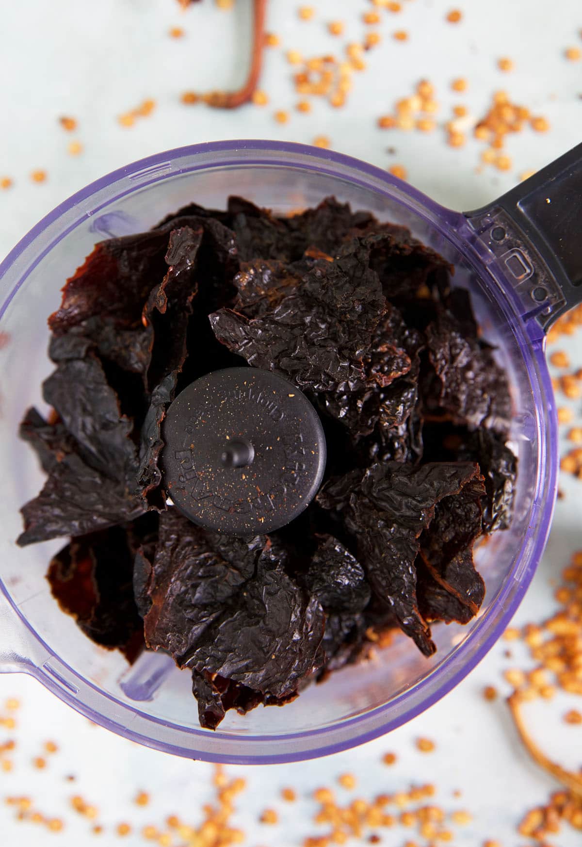 Ancho chilis are placed in a food processor.