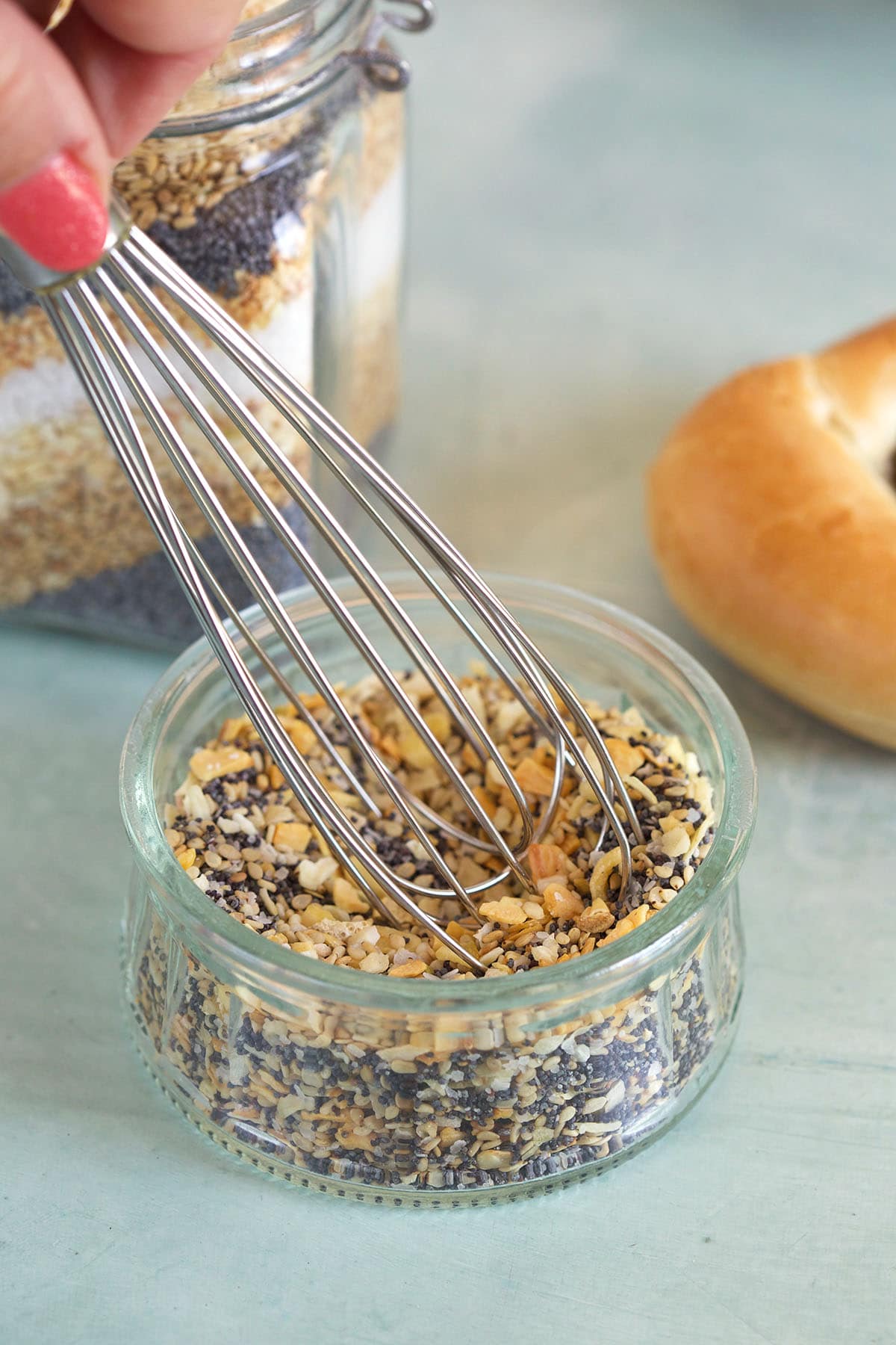 Everything Bagel Seasoning being whisked in a small jar.