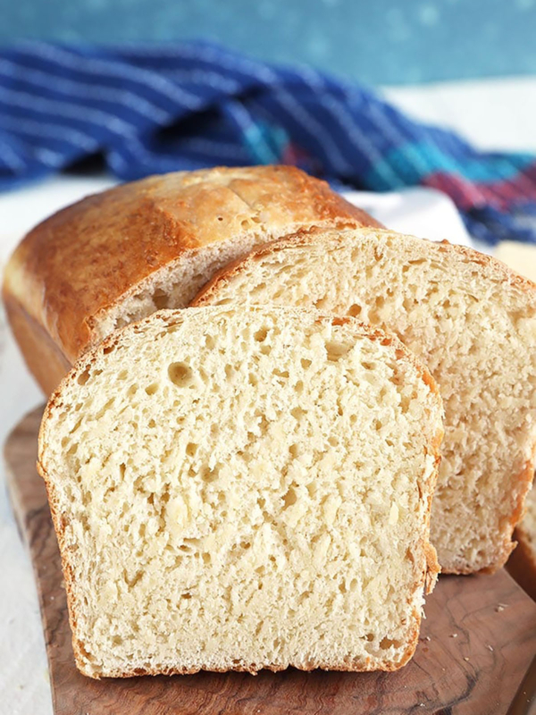 Homemade white bread on a wood bread board.
