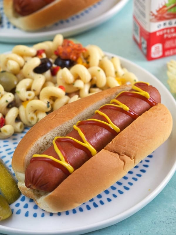 A hot dog is drizzled with ketchup and mustard.
