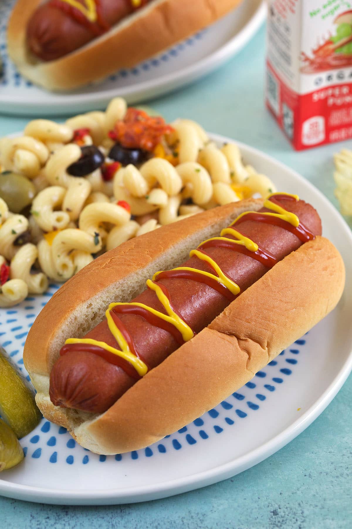 A hot dog is drizzled with ketchup and mustard.