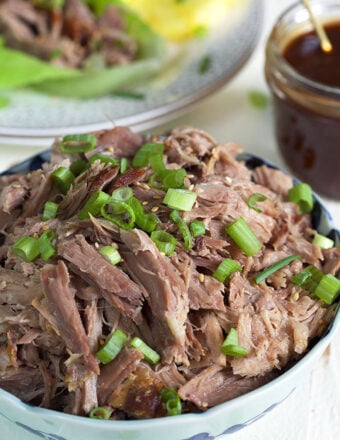 Kalua Pork in a blue and white bowl on a white background.
