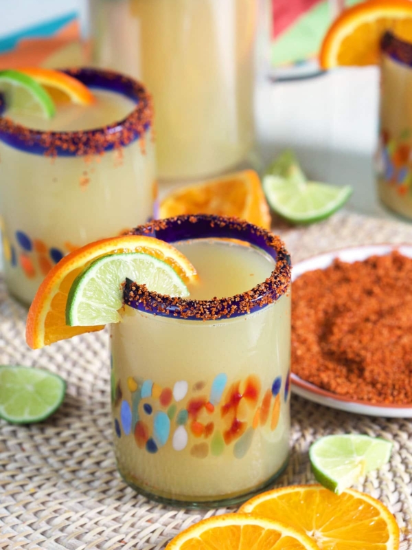 Orange and lime slices garnish a glass.
