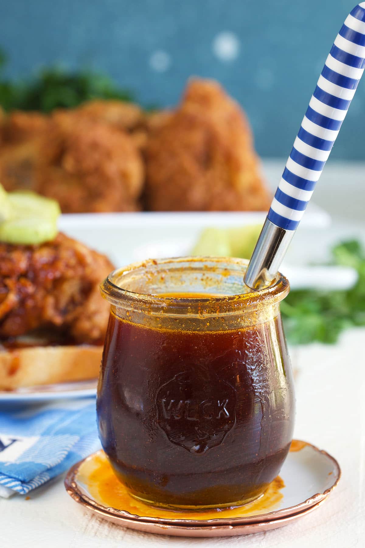 A spoon is placed in a jar of hot sauce.