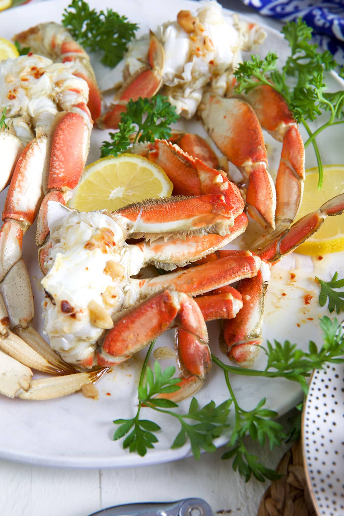 Crab legs are cooked and arranged on a white plate.