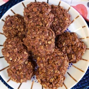 A batch of chocolate oatmeal cookies are on a plate.