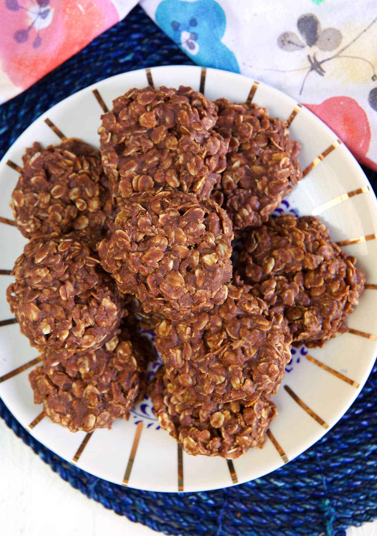 A batch of chocolate oatmeal cookies are on a plate.