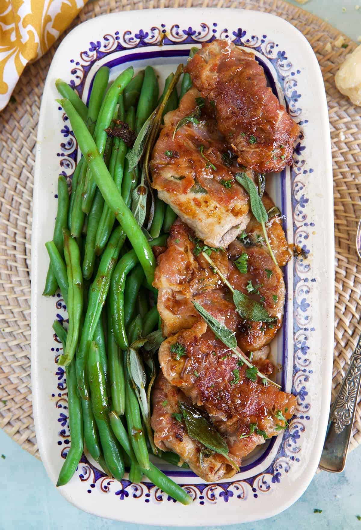 Veal Saltimbocca on a serving platter with green beans.