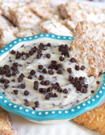 A small blue and white bowl is filled with sweet cannoli dip.