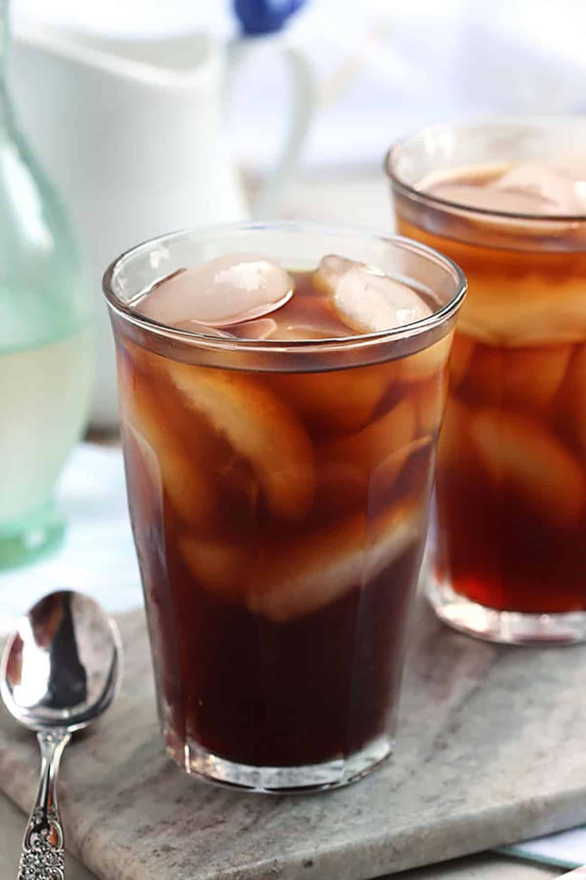 Cold Brew Coffee in a glass with ice on a marble board.