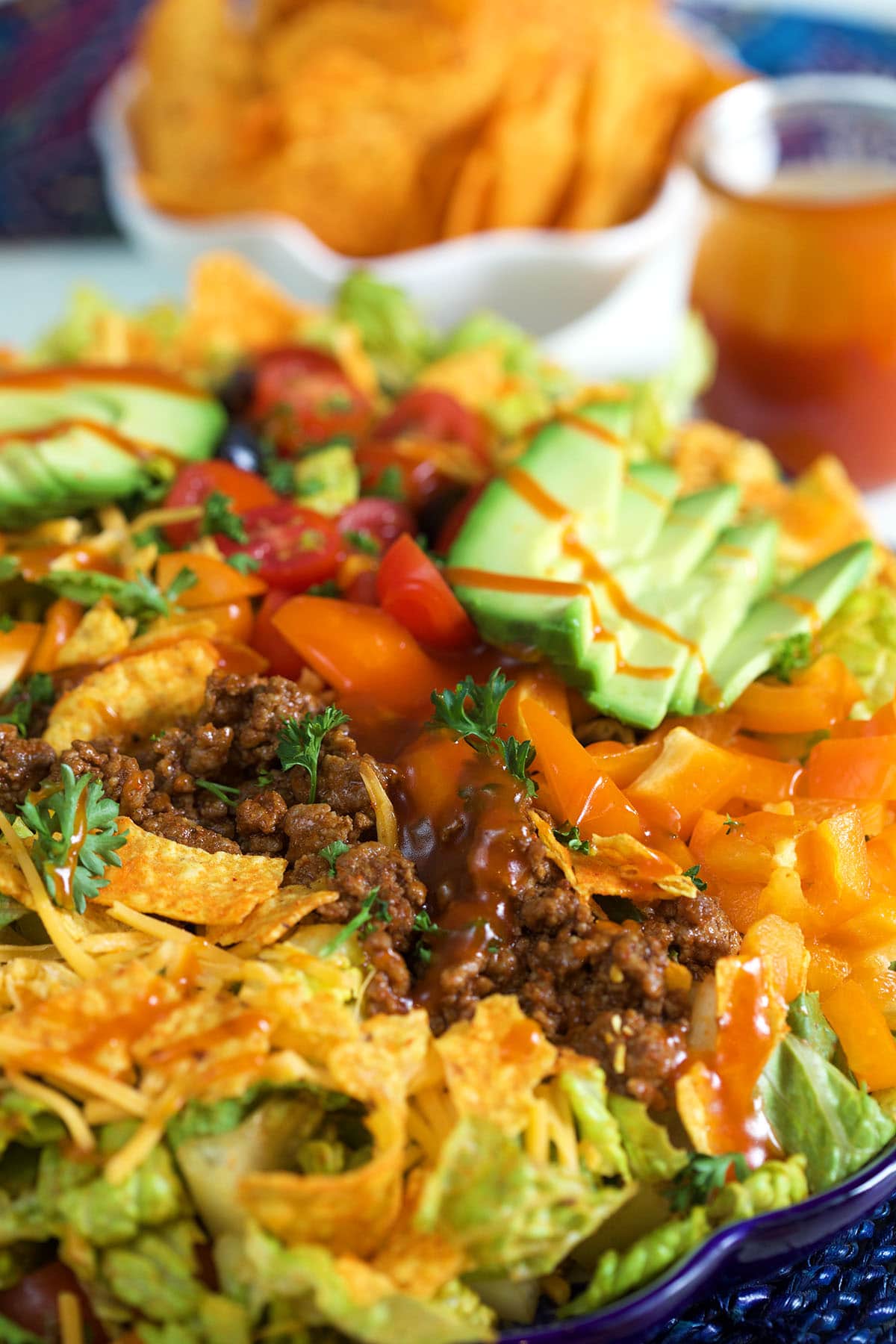 A taco salad is drizzled with dressing. 