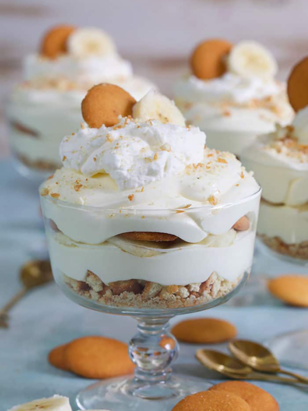 Banana Pudding in a small trifle dish with a Nilla wafer on top.