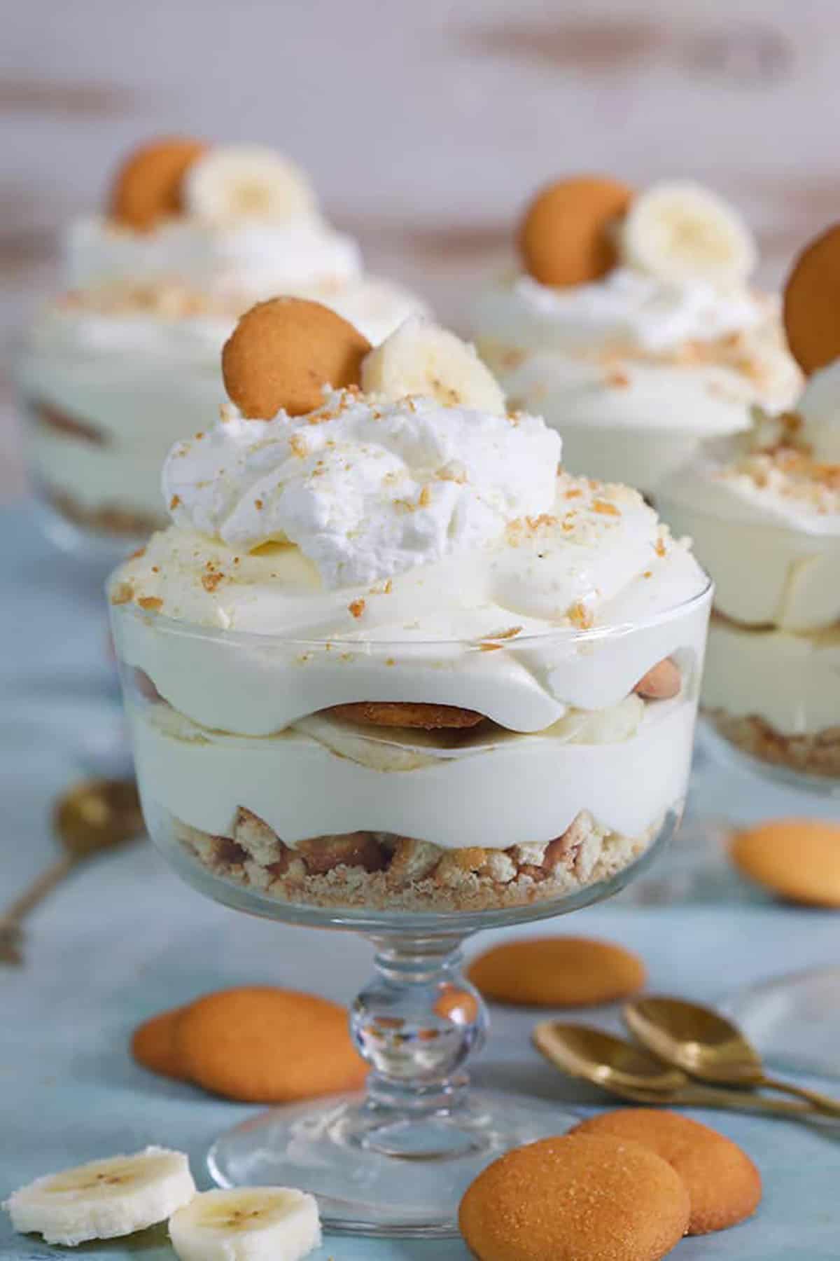 Banana Pudding in a small trifle dish with a Nilla wafer on top.