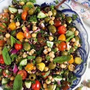 overhead shot of mediterranean chickpea salad in a blue and white bowl.